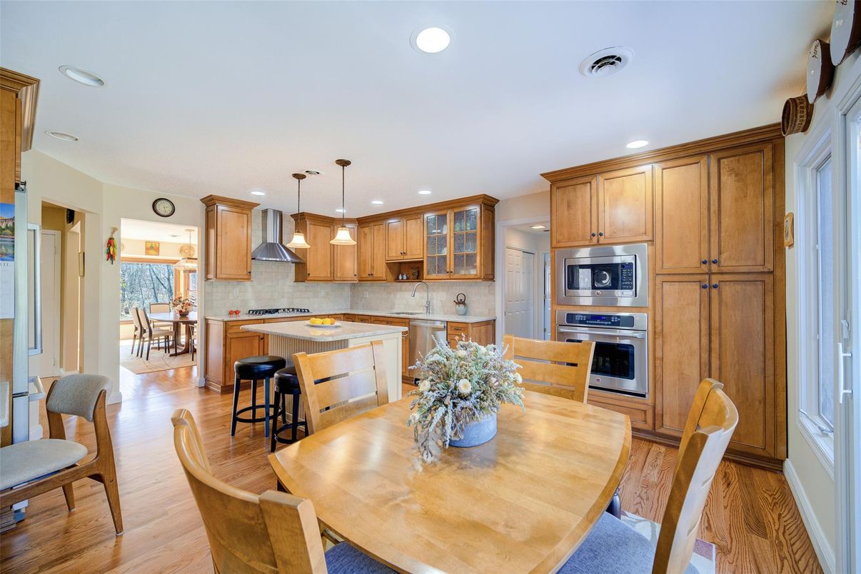 Dining room, Interior, Kitchen, Pendant Lights, Recessed Lighting, Stainless Steel Appliances, Wood Texture Flooring