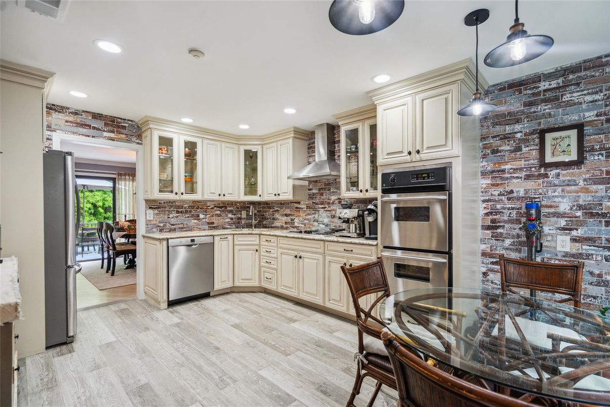 Dining room, Interior, Kitchen, Pendant Lights, Recessed Lighting, Stainless Steel Appliances, Stone Walls, Wood Texture Flooring