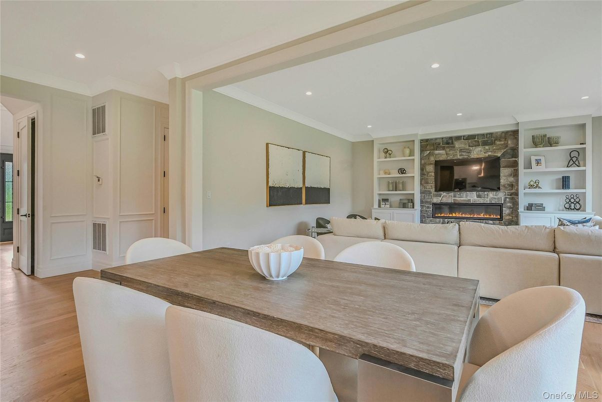 Dining room, Fireplace, Interior, Living room, Recessed Lighting, Stone Walls, Wood Texture Flooring