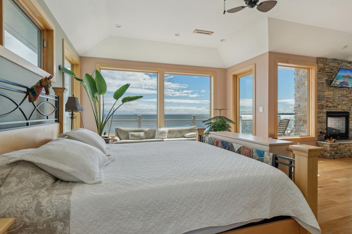 Bedroom, Fireplace, Interior, Recessed Lighting, Stone Walls, Water, Wood Texture Flooring