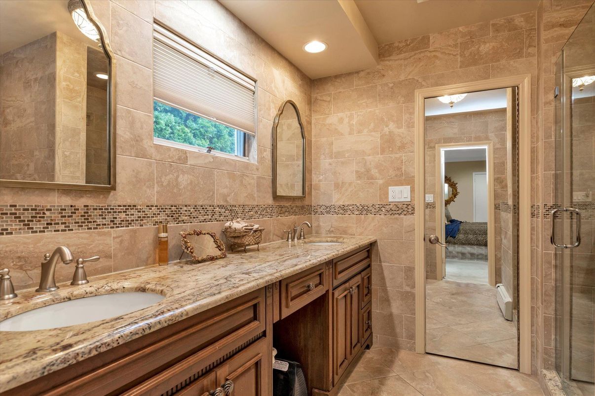 Bathroom, Dual Sink Vanities, Glass Shower, Interior, Recessed Lighting, Stone Walls