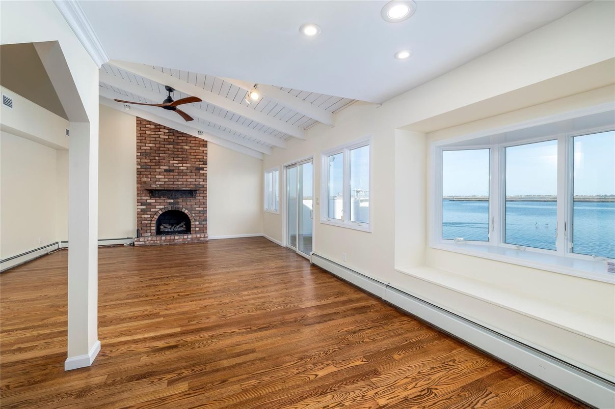 Empty room, Fireplace, Interior, Recessed Lighting, Stone Walls, Water, Wood Texture Flooring