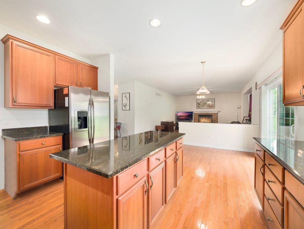 Fireplace, Interior, Kitchen, Living room, Pendant Lights, Recessed Lighting, Stainless Steel Appliances, Wood Texture Flooring