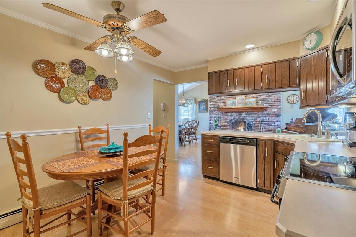 Dining room, Fireplace, Interior, Kitchen, Recessed Lighting, Stainless Steel Appliances, Stone Walls, Wood Texture Flooring