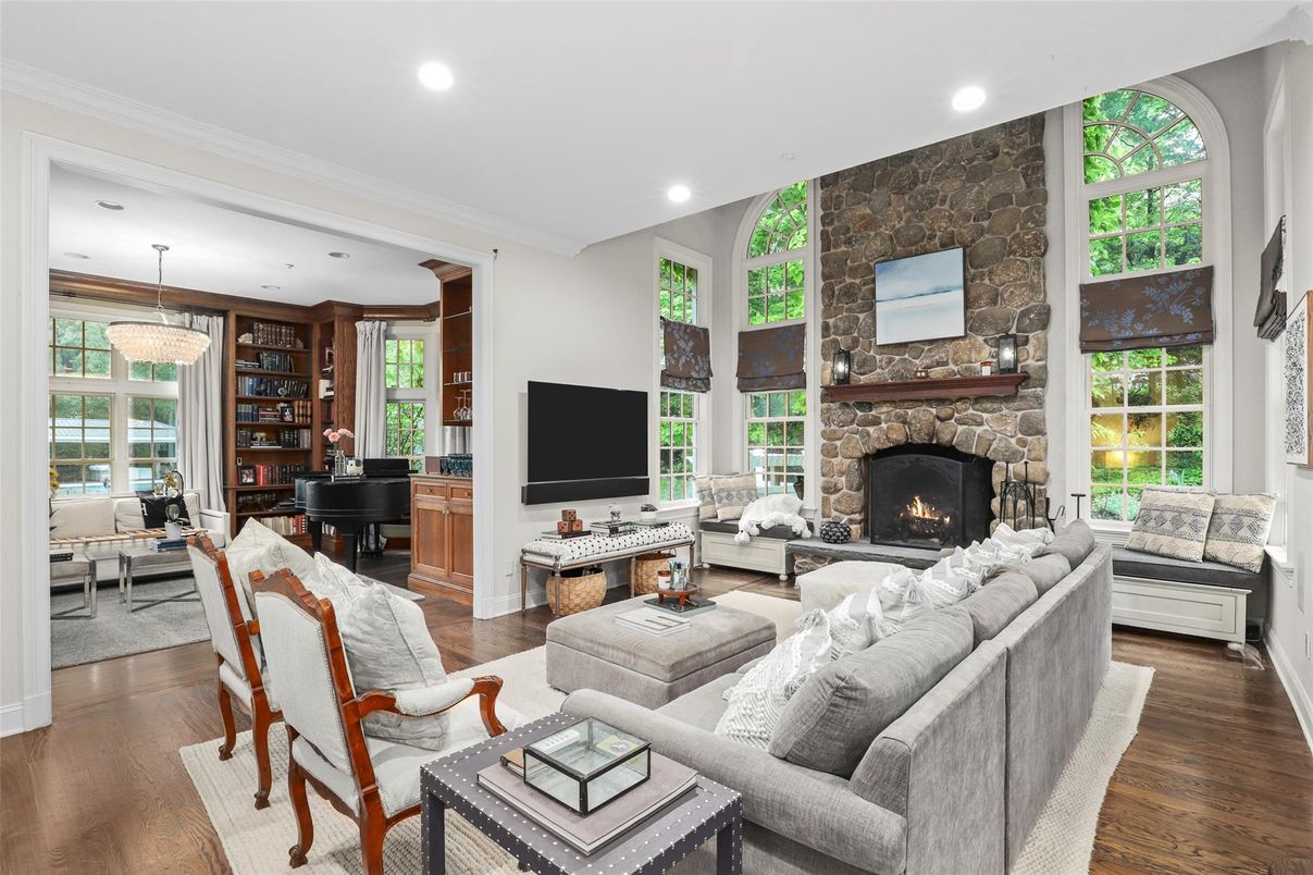Chandelier, Fireplace, Interior, Living room, Piano, Recessed Lighting, Stone Walls, Wood Texture Flooring