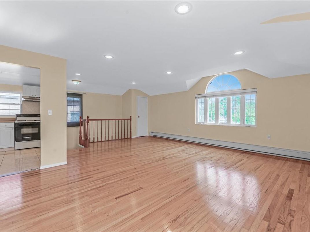 Empty room, Interior, Kitchen, Recessed Lighting, Stainless Steel Appliances, Wood Texture Flooring