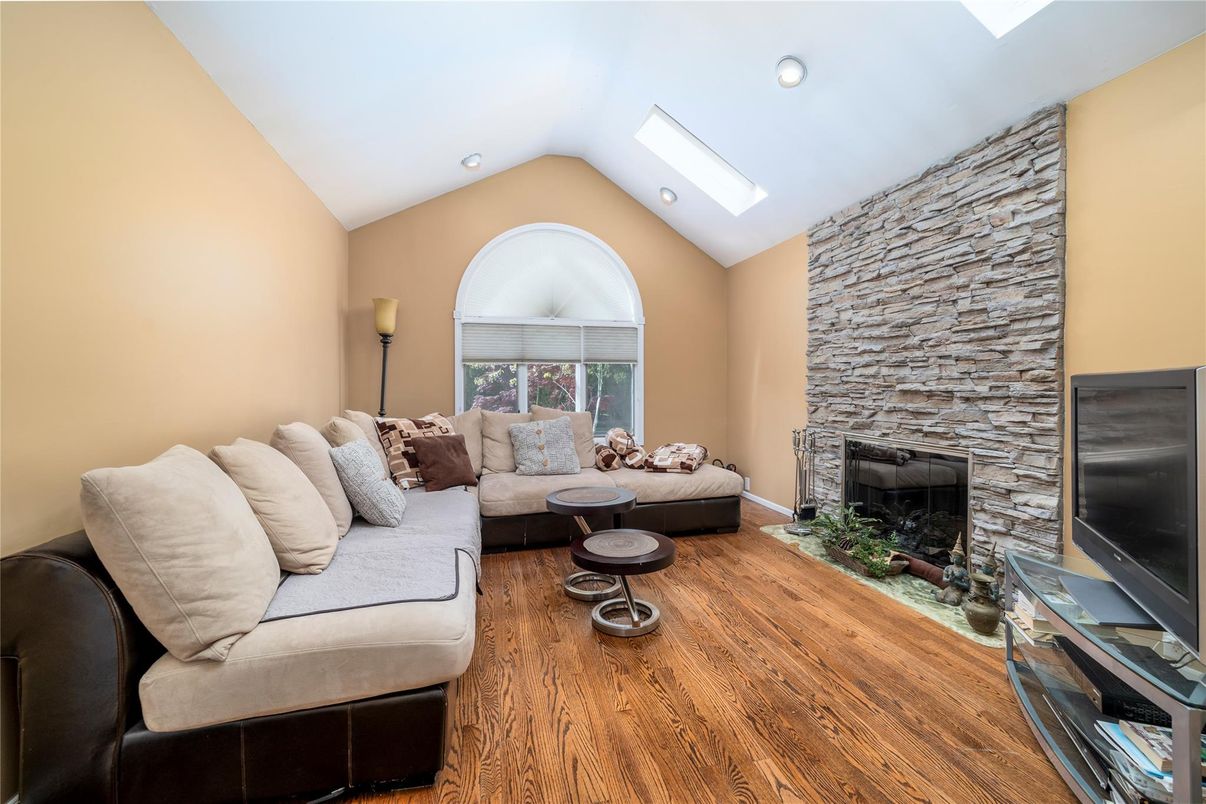 Fireplace, Interior, Living room, Recessed Lighting, Stone Walls, Wood Texture Flooring
