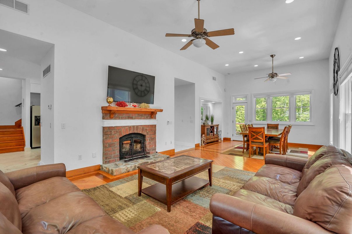 Dining room, Fireplace, Interior, Living room, Recessed Lighting, Wood Texture Flooring