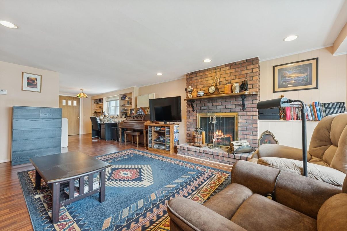 Fireplace, Interior, Living room, Piano, Recessed Lighting, Stone Walls, Wood Texture Flooring