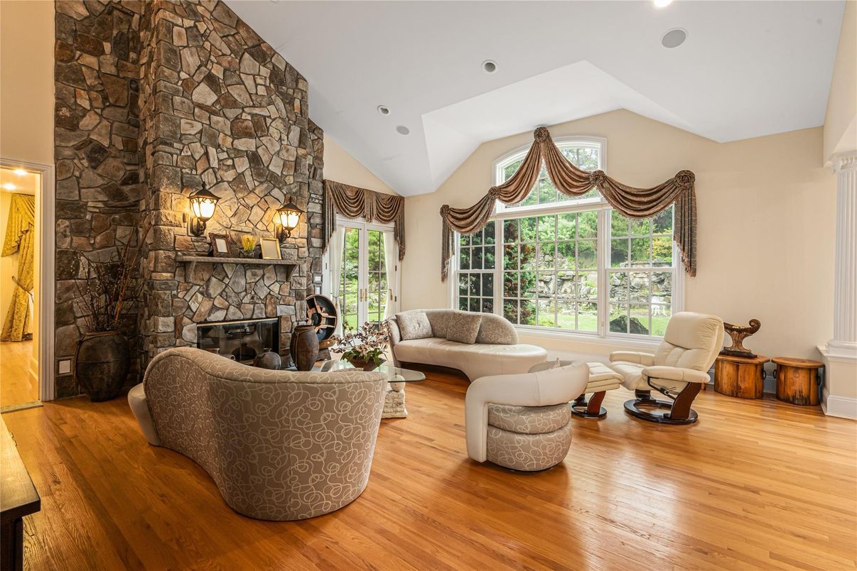 Fireplace, Interior, Living room, Recessed Lighting, Stone Walls, Wood Texture Flooring