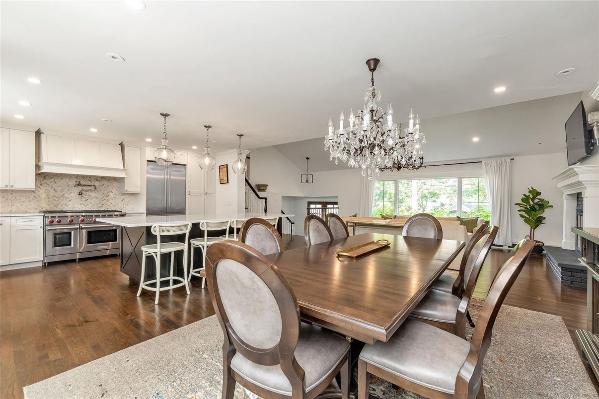 Chandelier, Dining room, Fireplace, Interior, Kitchen, Pendant Lights, Recessed Lighting, Stainless Steel Appliances, Wood Texture Flooring