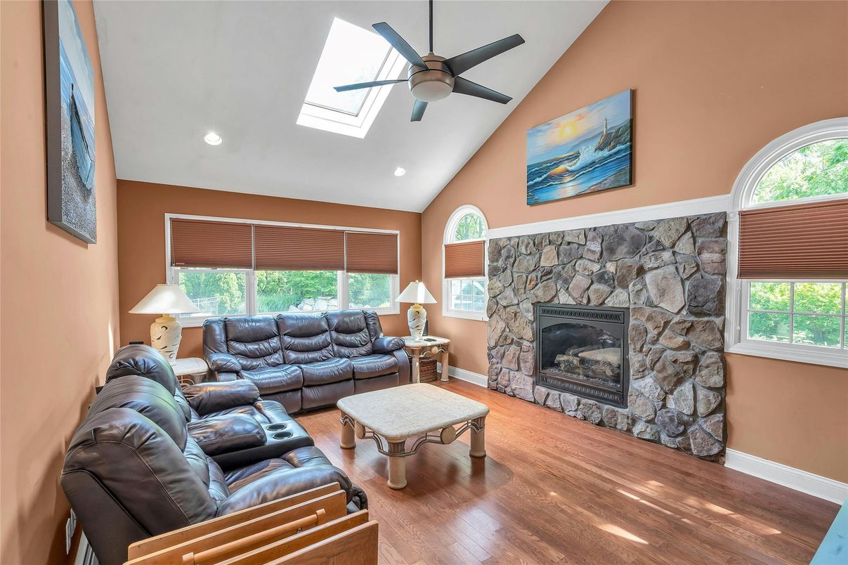 Fireplace, Interior, Living room, Recessed Lighting, Stone Walls, Wood Texture Flooring