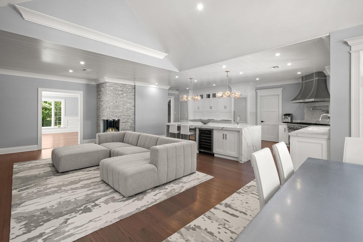 Chandelier, Fireplace, Interior, Kitchen, Living room, Pendant Lights, Recessed Lighting, Stainless Steel Appliances, Stone Walls, Wood Texture Flooring