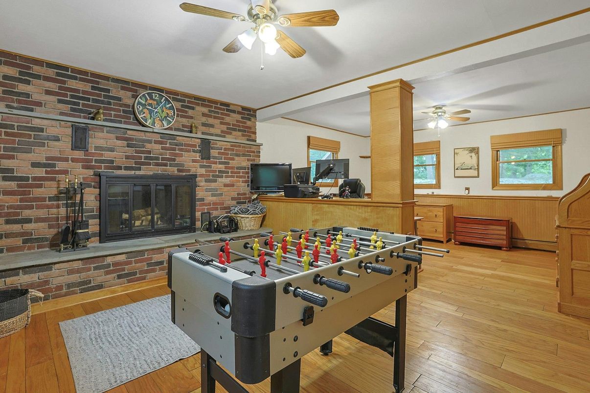 Fireplace, Game Room, Interior, Stone Walls, Wood Texture Flooring