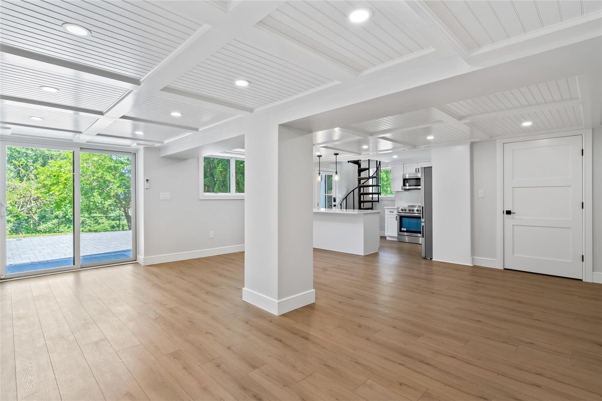 Empty room, Interior, Kitchen, Recessed Lighting, Stainless Steel Appliances, Wood Texture Flooring