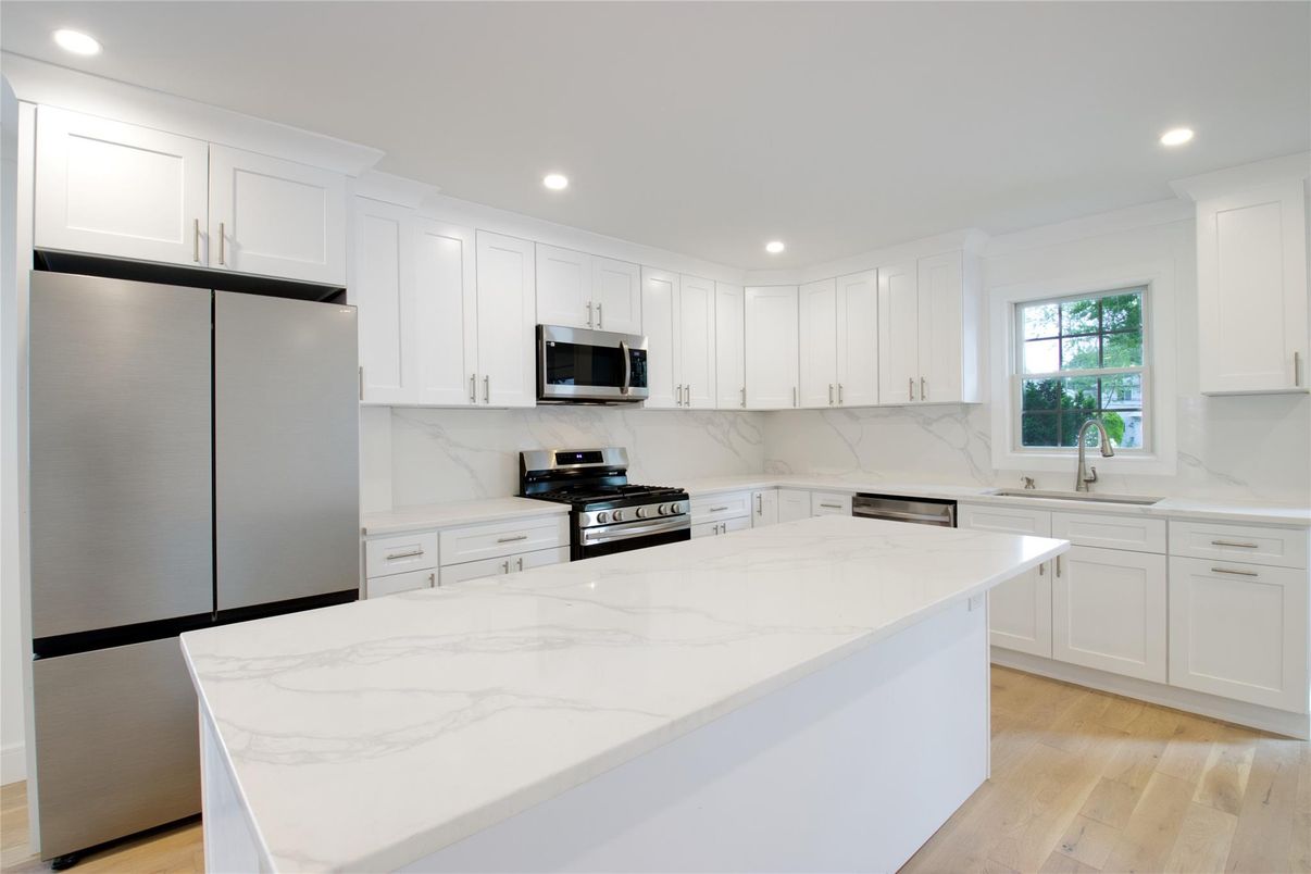 Interior, Kitchen, Marble Walls, Recessed Lighting, Stainless Steel Appliances, Wood Texture Flooring