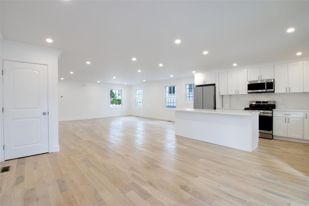 Empty room, Interior, Kitchen, Recessed Lighting, Stainless Steel Appliances, Wood Texture Flooring