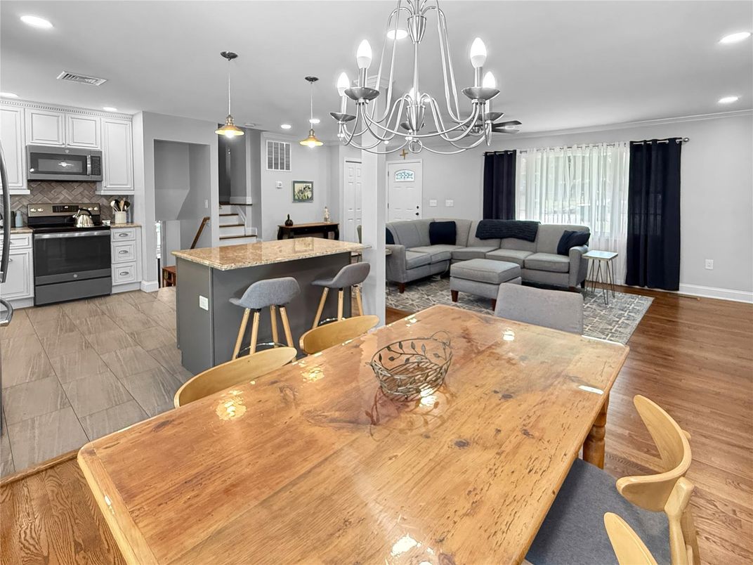 Chandelier, Dining room, Interior, Kitchen, Living room, Pendant Lights, Recessed Lighting, Stainless Steel Appliances, Wood Texture Flooring