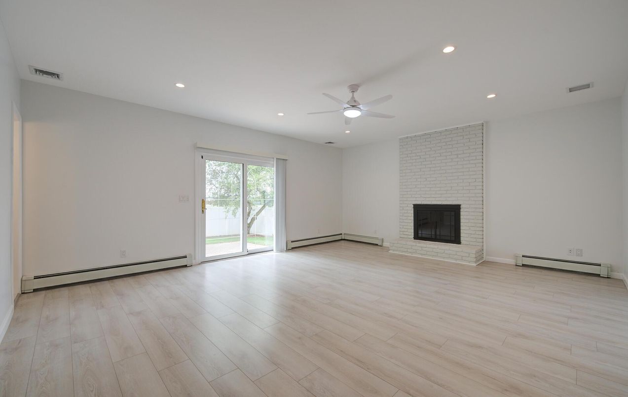Empty room, Fireplace, Interior, Recessed Lighting, Stone Walls, Wood Texture Flooring