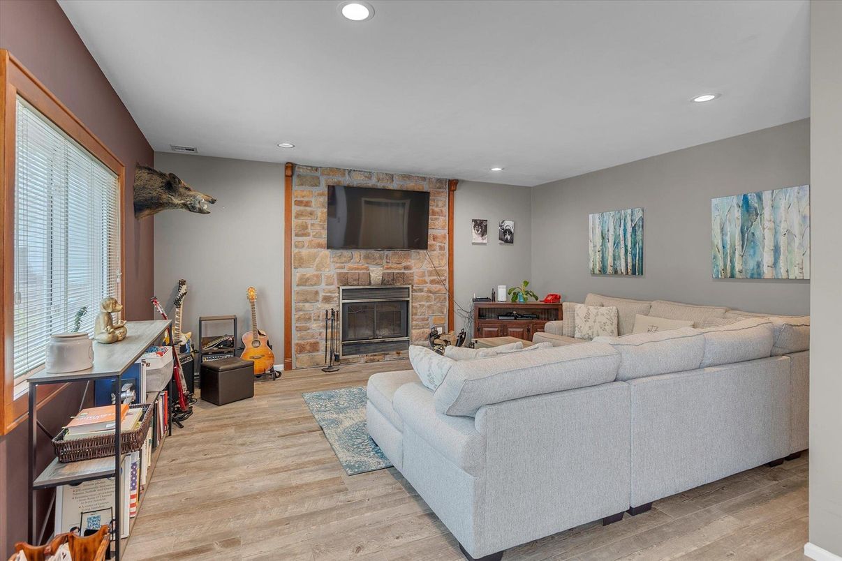 Fireplace, Interior, Living room, Recessed Lighting, Stone Walls, Wood Texture Flooring