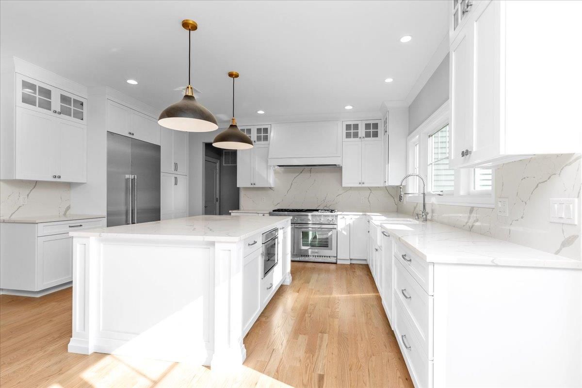 Interior, Kitchen, Marble Walls, Pendant Lights, Recessed Lighting, Stainless Steel Appliances, Wood Texture Flooring