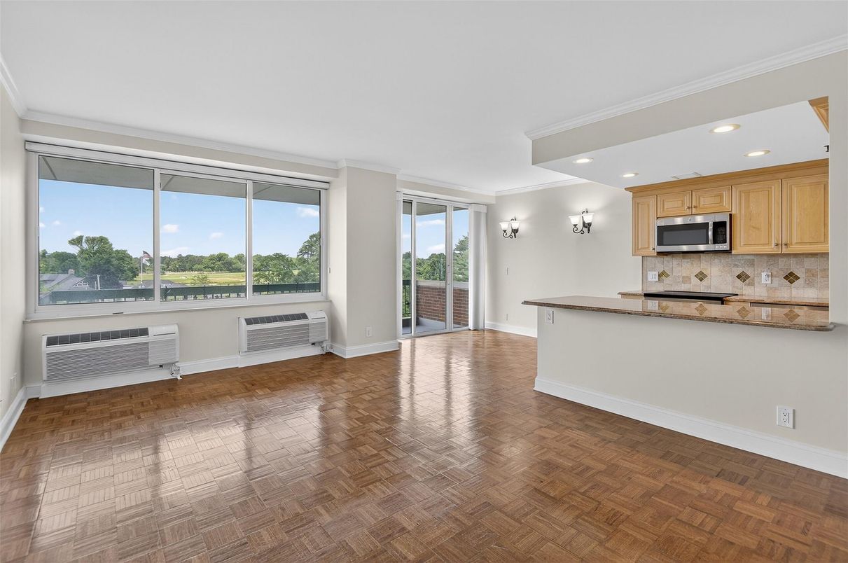 Empty room, Interior, Kitchen, Recessed Lighting, Stainless Steel Appliances, Wood Texture Flooring