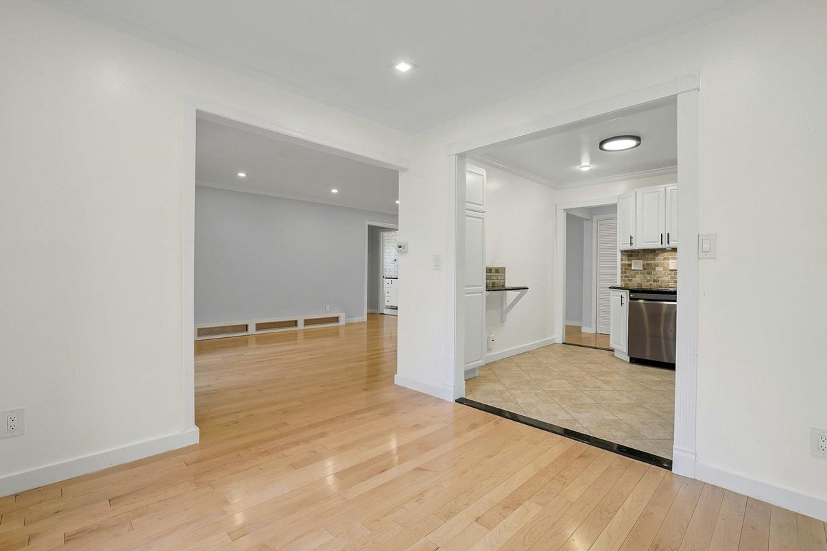 Empty room, Interior, Kitchen, Recessed Lighting, Stainless Steel Appliances, Wood Texture Flooring