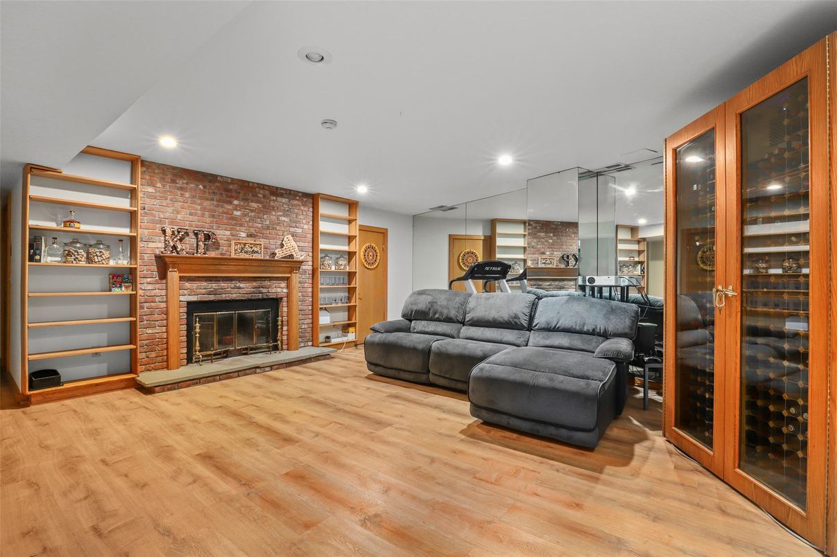 Fireplace, Fitness Equipment, Interior, Living room, Recessed Lighting, Stone Walls, Wood Texture Flooring
