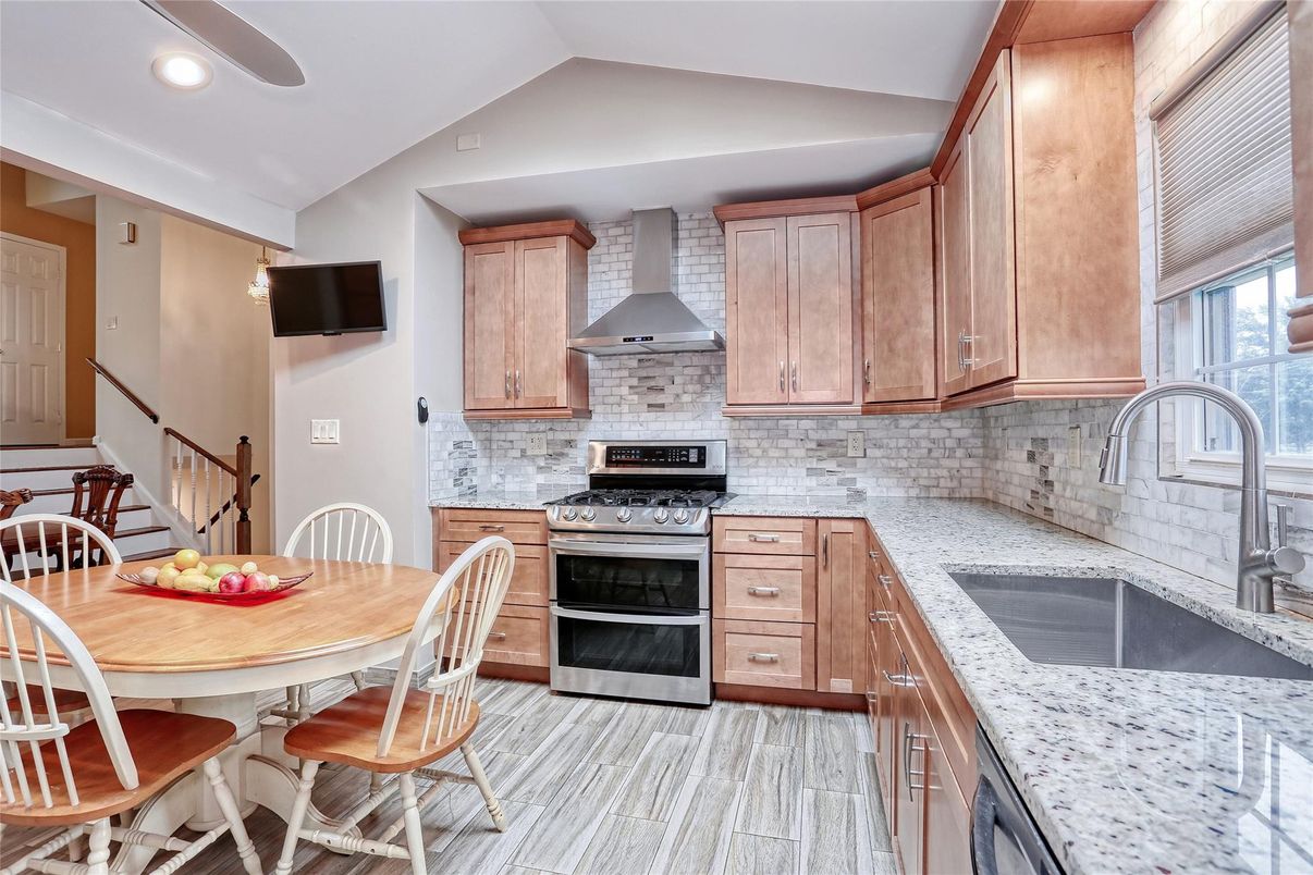 Dining room, Interior, Kitchen, Recessed Lighting, Stainless Steel Appliances, Stone Walls, Wood Texture Flooring