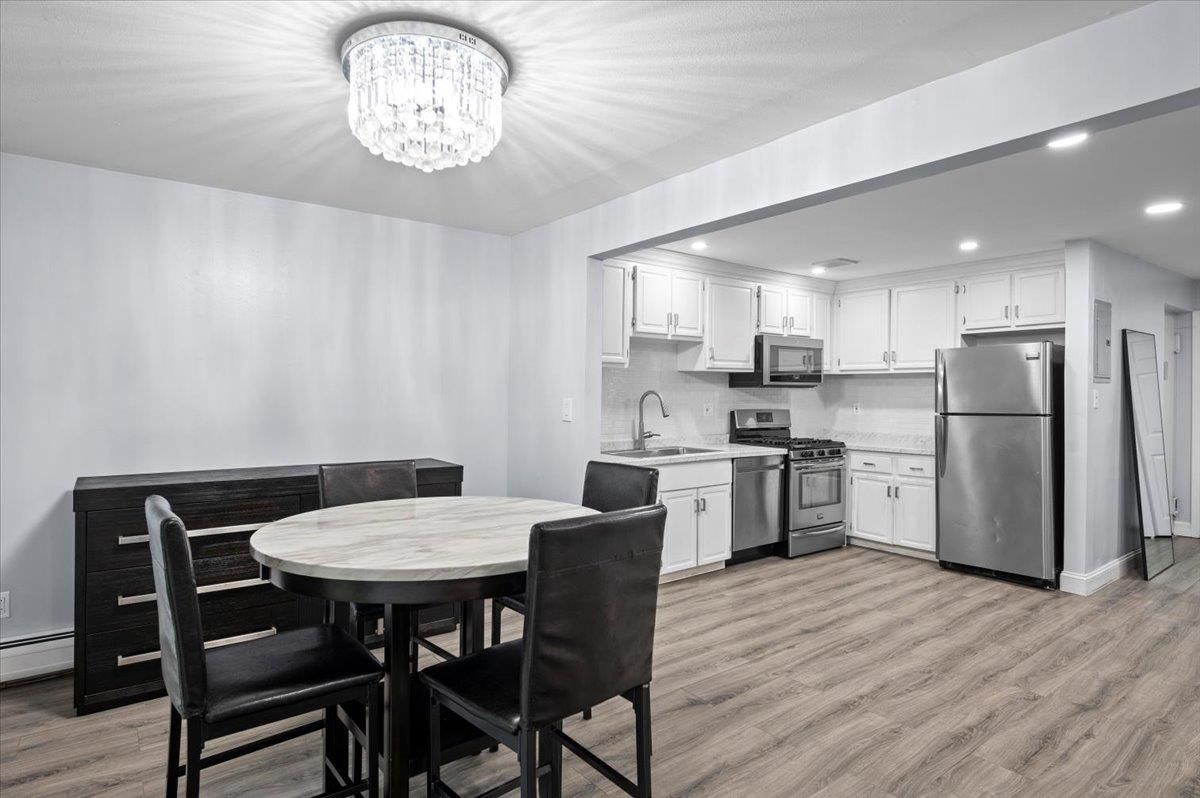 Chandelier, Dining room, Interior, Kitchen, Recessed Lighting, Stainless Steel Appliances, Wood Texture Flooring