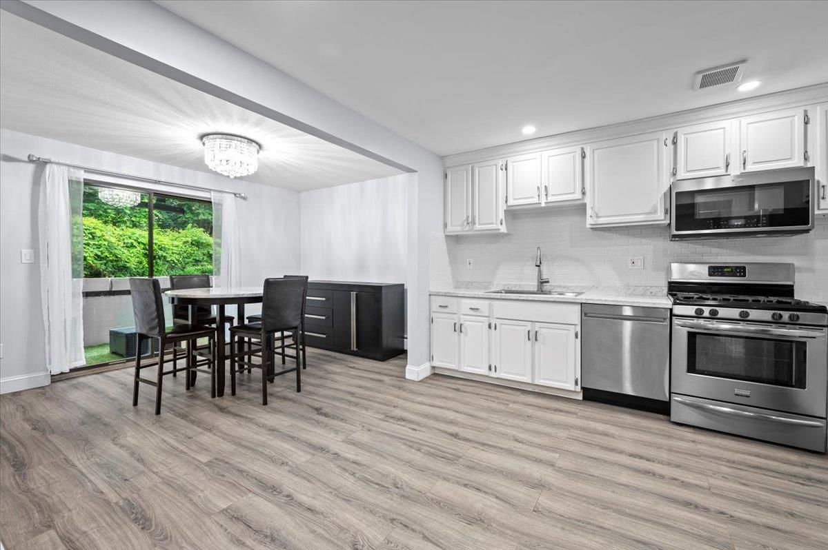Chandelier, Dining room, Interior, Kitchen, Recessed Lighting, Stainless Steel Appliances, Wood Texture Flooring