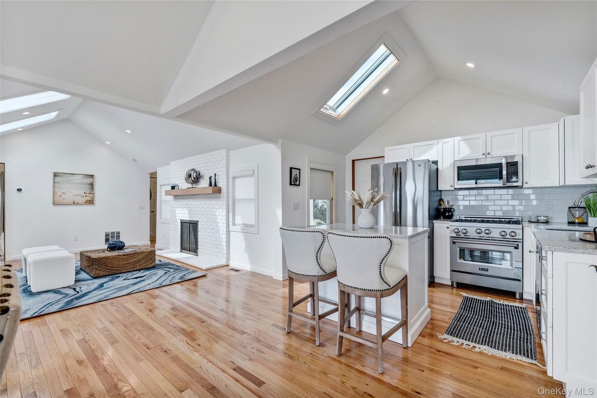 Fireplace, Interior, Kitchen, Recessed Lighting, Stainless Steel Appliances, Stone Walls, Wood Texture Flooring