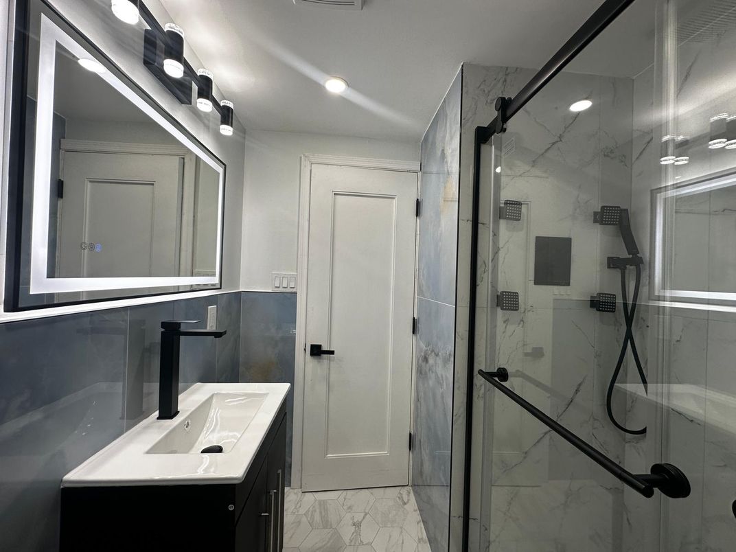 Bathroom, Dual Sink Vanities, Glass Shower, Interior, Marble, Marble Walls, Recessed Lighting