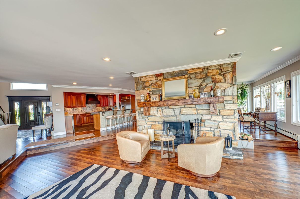 Dining room, Fireplace, Interior, Kitchen, Living room, Recessed Lighting, Stone Walls, Wood Texture Flooring