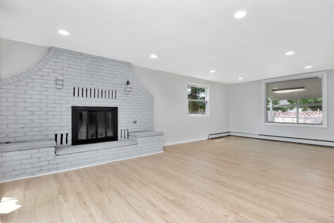 Empty room, Fireplace, Interior, Recessed Lighting, Stone Walls, Wood Texture Flooring