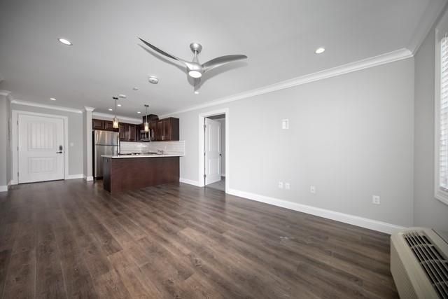 Empty room, Interior, Kitchen, Pendant Lights, Recessed Lighting, Stainless Steel Appliances, Wood Texture Flooring