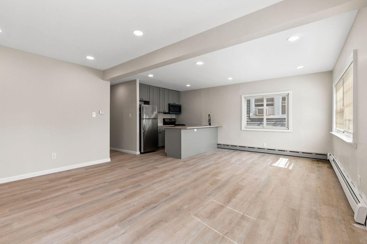Empty room, Interior, Kitchen, Recessed Lighting, Stainless Steel Appliances, Wood Texture Flooring