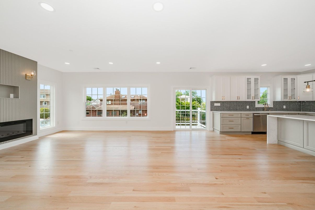 Empty room, Fireplace, Interior, Kitchen, Pendant Lights, Recessed Lighting, Stainless Steel Appliances, Wood Texture Flooring