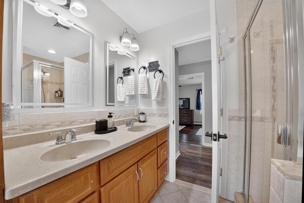 Bathroom, Dual Sink Vanities, Glass Shower, Interior, Recessed Lighting, Wood Texture Flooring