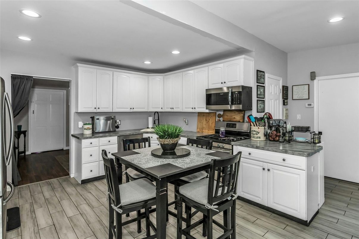 Dining room, Interior, Kitchen, Recessed Lighting, Stainless Steel Appliances, Wood Texture Flooring