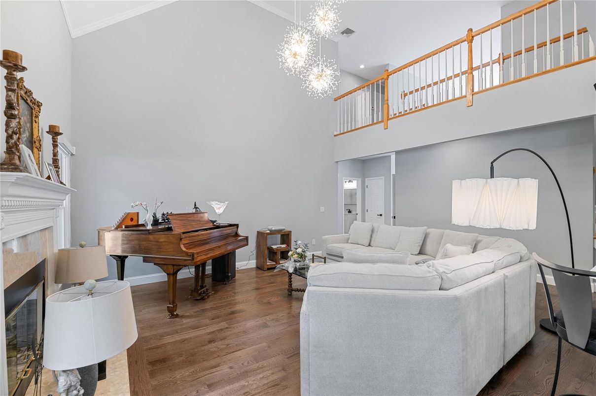Chandelier, Fireplace, Interior, Living room, Piano, Recessed Lighting, Wood Texture Flooring