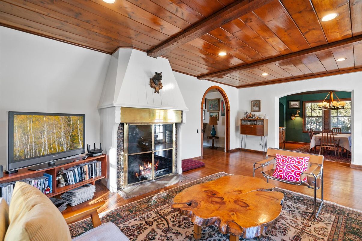 Chandelier, Dining room, Fireplace, Interior, Living room, Recessed Lighting, Wooden Beams, Wooden Ceilings, Wood Texture Flooring
