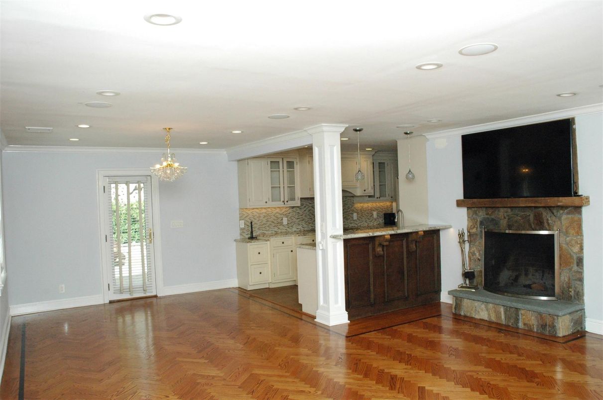 Chandelier, Empty room, Fireplace, Interior, Kitchen, Pendant Lights, Recessed Lighting, Wood Texture Flooring