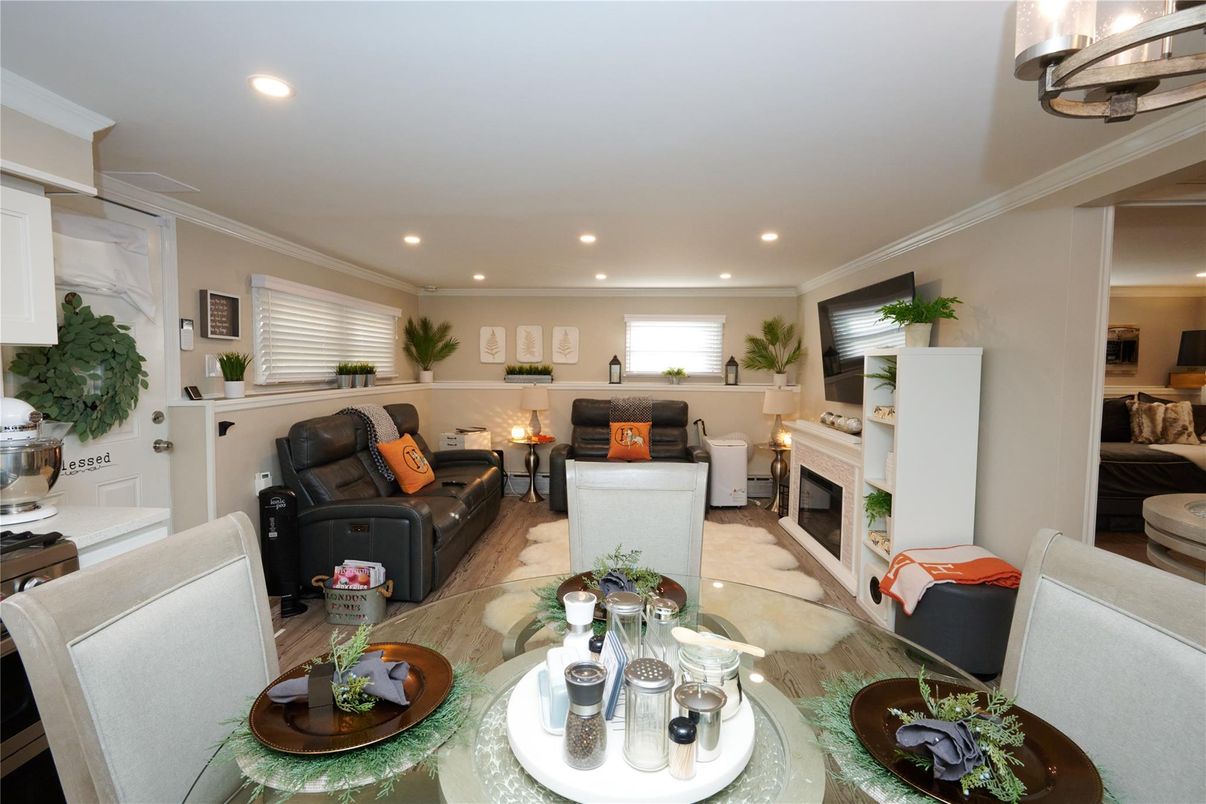 Dining room, Fireplace, Interior, Living room, Recessed Lighting, Wood Texture Flooring