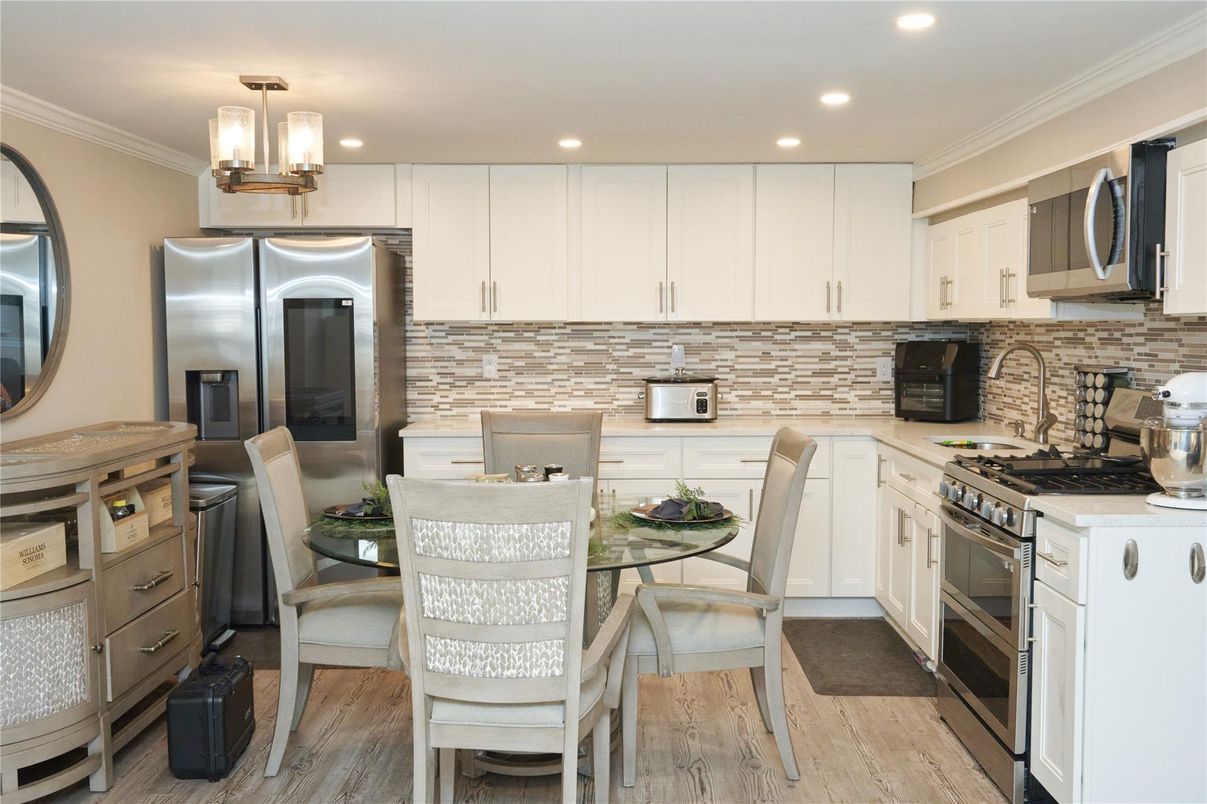 Dining room, Interior, Kitchen, Recessed Lighting, Stainless Steel Appliances, Stone Walls, Wood Texture Flooring