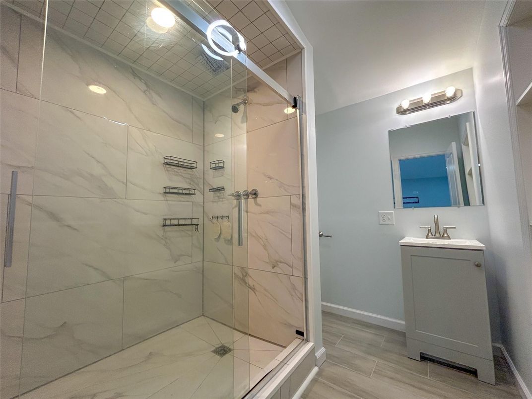 Bathroom, Glass Shower, Interior, Marble Walls, Recessed Lighting, Wood Texture Flooring
