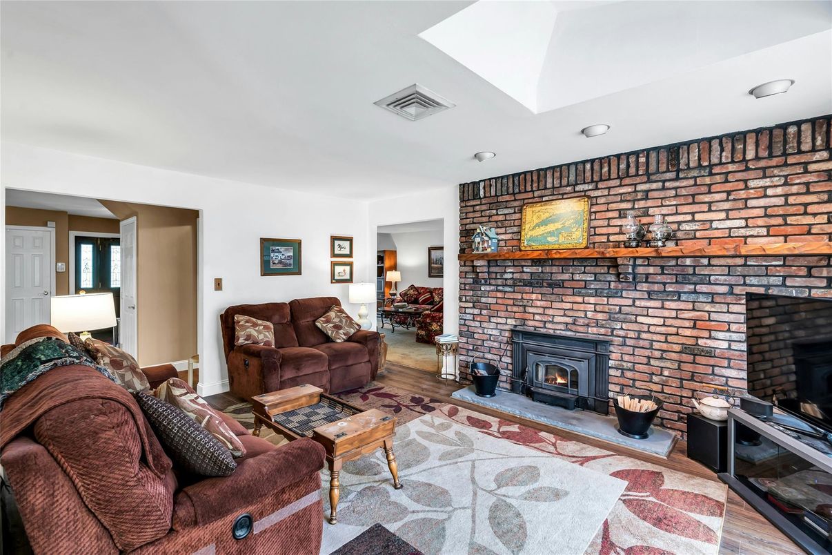 Fireplace, Interior, Living room, Recessed Lighting, Stone Walls, Wood Texture Flooring