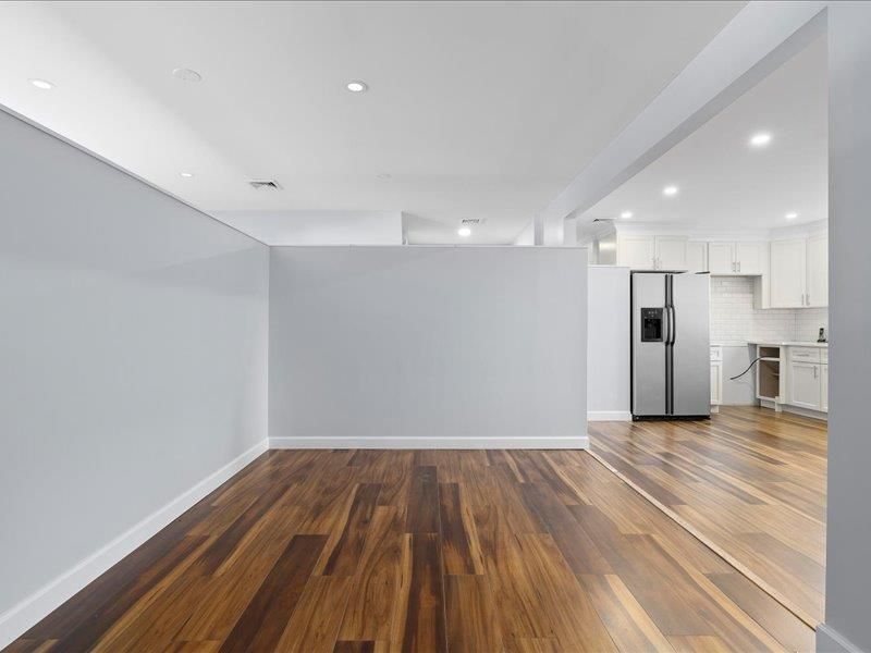 Empty room, Interior, Kitchen, Recessed Lighting, Stainless Steel Appliances, Wood Texture Flooring