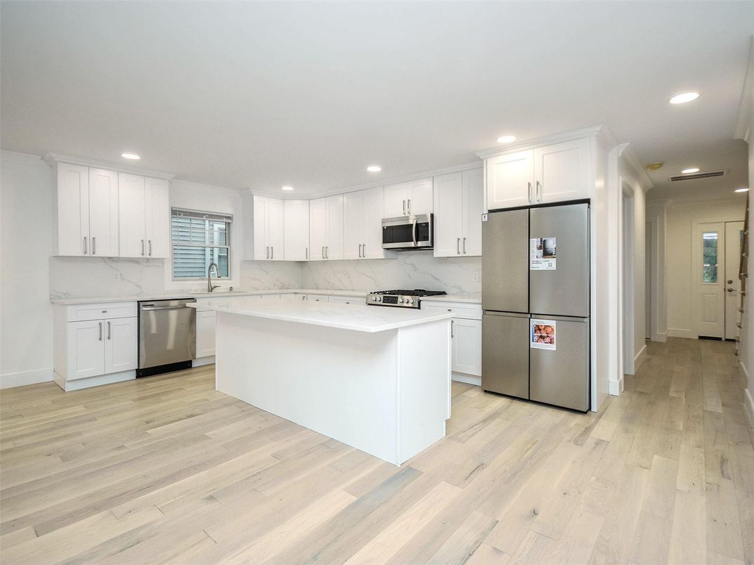 Interior, Kitchen, Marble Walls, Recessed Lighting, Stainless Steel Appliances, Wood Texture Flooring