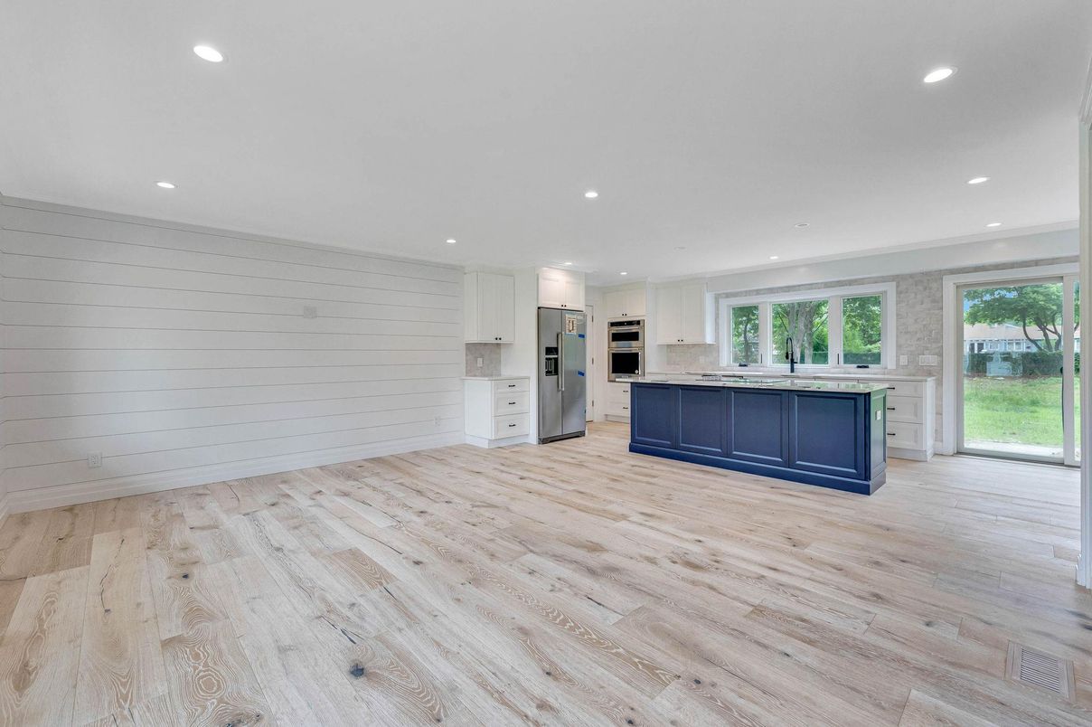 Empty room, Interior, Kitchen, Recessed Lighting, Stainless Steel Appliances, Wood Texture Flooring